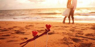 A couple walk on the beach during a romantic Valentine's Getaway