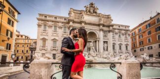 most romantic places in europe - couple kissing in front on rome's trevi fountain
