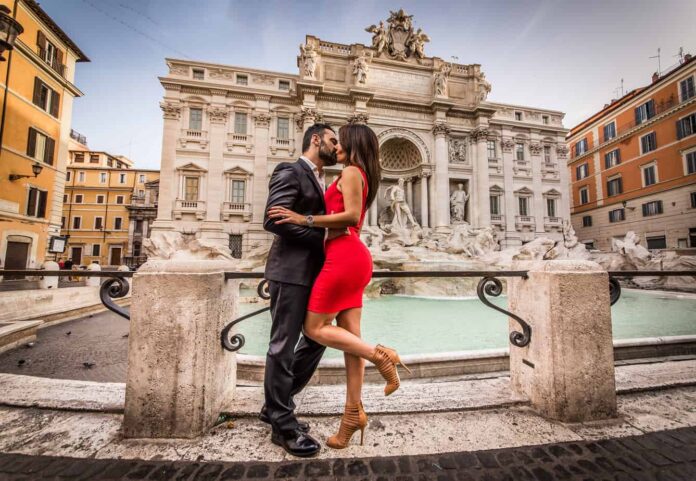 most romantic places in europe - couple kissing in front on rome's trevi fountain