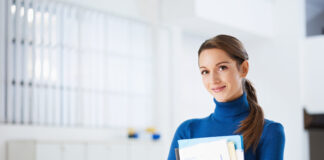 business woman holding reports and looking at camera. Copy space