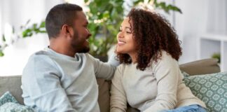 couple sitting on couch looking at one another