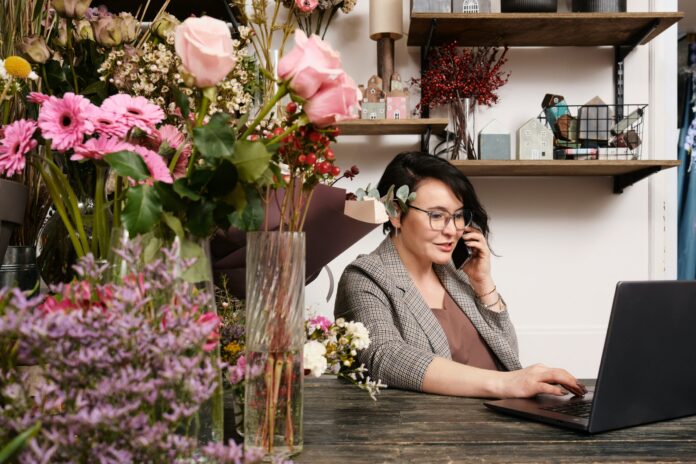 woman on a call sitting at a computer