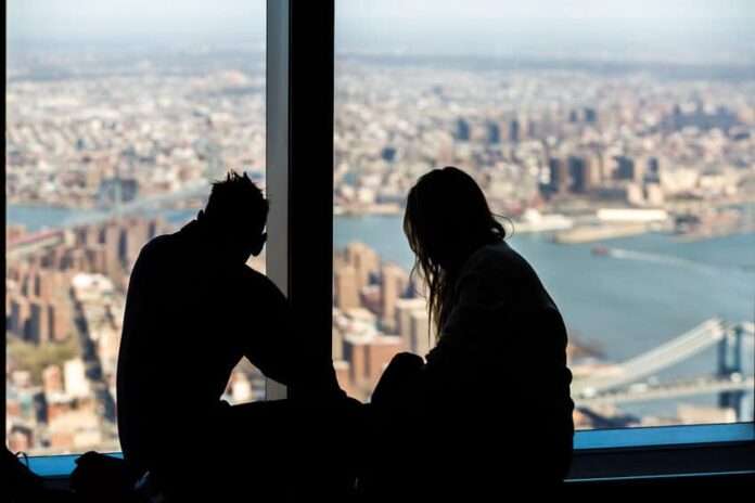 silhouette of a couple on top of a building