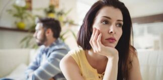 couple sitting away from each other upset