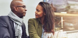 man and women sitting talking at dinner